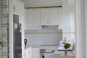 Enjoy cooking in this well-equipped kitchen with an oven and range hood.