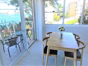 Enjoy a serene view of the bridge and water from the large window, with a comfortable seating area and outdoor access.