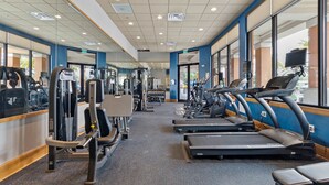 A gym with treadmills, weight machines, and free weights.