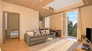 A modern living room with a sofa, coffee table, and a TV.