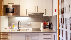 A modern kitchen with a built-in microwave, stainless steel oven, and a coffee machine. - Apartment "Haus Excelsior Top 2" with Mountain View, Balcony & Wi-Fi (Seefeld in Tirol)