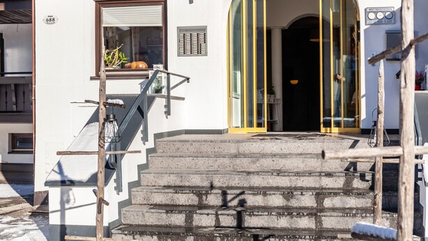 A hotel entrance with a sign reading 'EXCELSIOR,' a staircase leading up to the entrance, and a window with blinds. - Apartment "Haus Excelsior Top 2" with Mountain View, Balcony & Wi-Fi (Seefeld in Tirol)