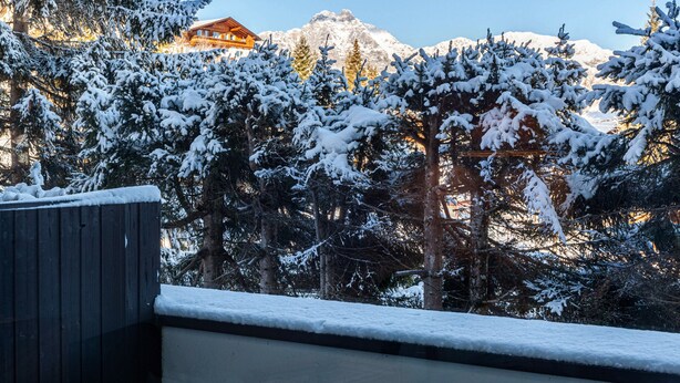 A snow-covered landscape with a mountain in the background and a building with a wooden facade. - Apartment "Haus Excelsior Top 3" with Mountain View, Balcony & Wi-Fi (Seefeld in Tirol)