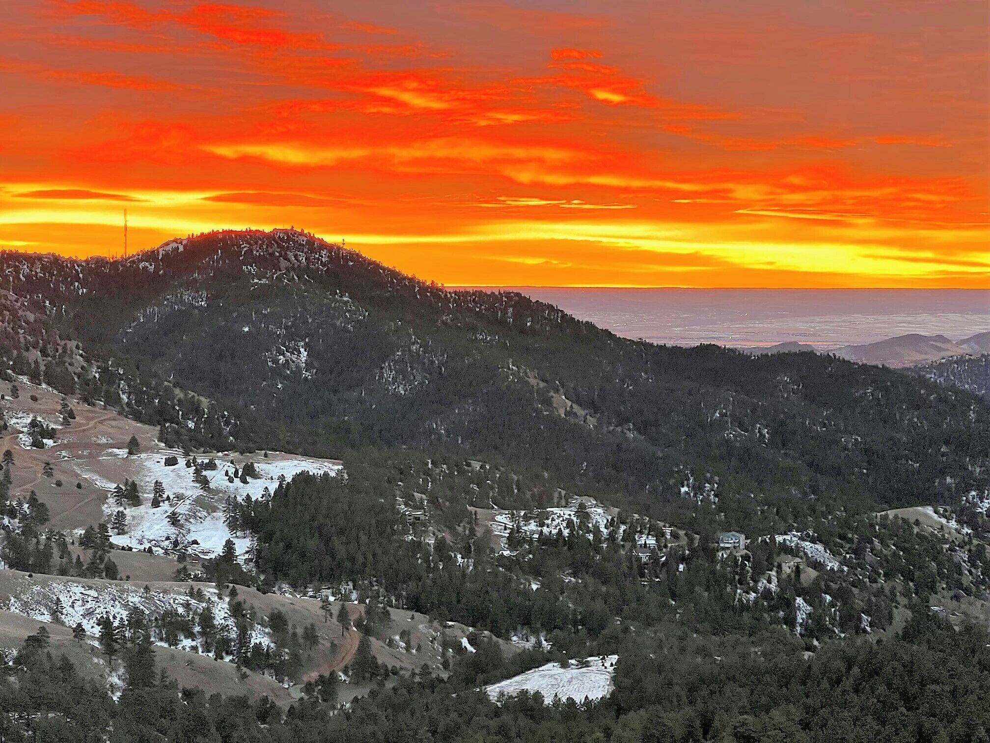 A mountainous landscape with a sunset.