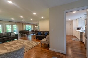 Cozy living area with a sofa, armchair, and dining table.