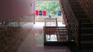 A staircase leading to a balcony with a view of greenery. - Valley View Hotel & Restaurant (Balakot)