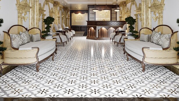 Un lobby de hotel lujoso con detalles dorados ornamentales, un mostrador de recepción central y un piso con diseño.