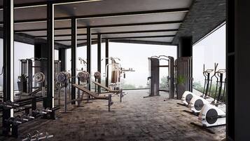 A modern gym with various exercise equipment, large windows, and a spacious layout.