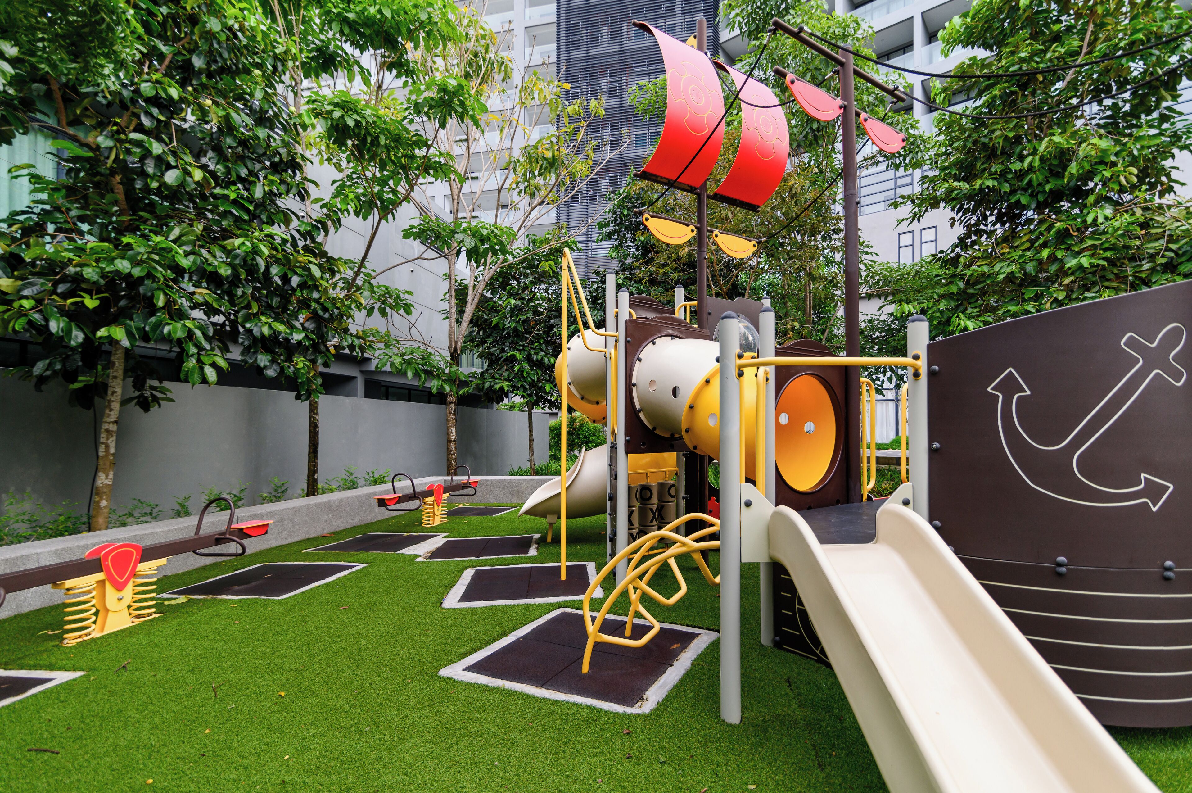 A playground with a slide, climbing structures, and a pirate-themed play area.