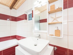 A modern bathroom with a large white sink, a mirror, and wooden shelves. - Amygdalia Villa (Zakynthos)