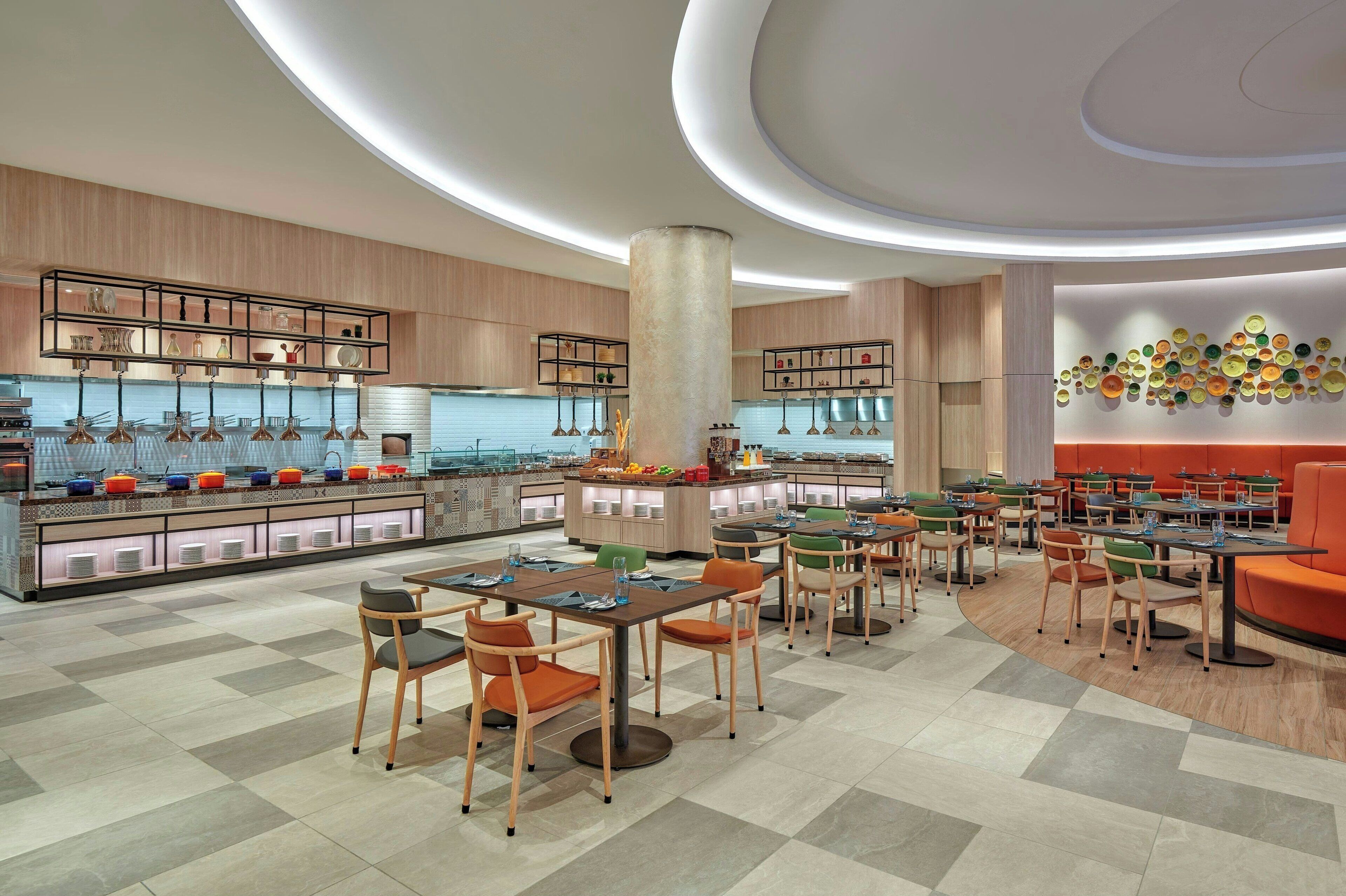 A modern restaurant with a central bar, multiple dining tables, and a variety of seating options.