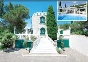A stone building with a central tower, a staircase leading to the entrance, and a pool area with a white fence. - Unique hilltop villa in Provence, stunning private pool, 6+bdrms + optional gite (Beaucaire)
