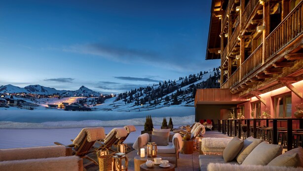A cozy outdoor seating area with lounge chairs and tables, overlooking a snowy mountain landscape. - Kesselspitze Hotel & Chalet, Valamar Collection (Tweng)