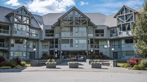 A multi-story hotel with a symmetrical facade, large windows, and a central entrance.