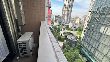 A high-rise building with a modern design, featuring a glass facade and a rooftop garden.