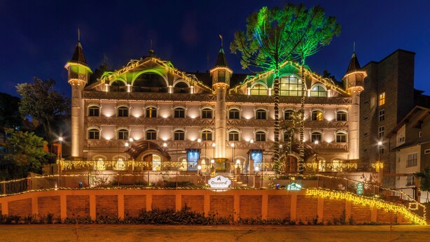 A large, historic building with multiple towers and arched windows, featuring a sign for 'Chocoland'. - Chocoland Hotel Gramado (Gramado)