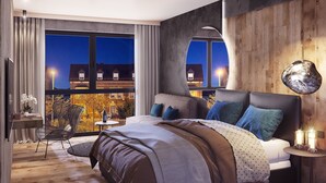 Une chambre moderne avec un grand lit, un bureau et une chaise. De grandes fenêtres offrent une vue sur les bâtiments environnants.