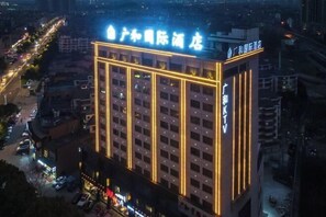 A high-rise hotel with illuminated signage and multiple floors. - Guanghe International Hotel (Yueyang)