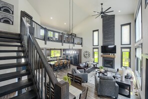A spacious living area with a staircase, a kitchen, and a fireplace. - Spacious 3,000 Sq. Ft. Lodge W/ Hot Tub, Walking Distance to Clubhouse Pool! (Lead)