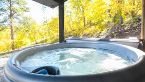 A hot tub with a view of autumn trees. - Secluded Cabin on 3 Acres w/ Hot Tub, Open Floor Plan, Starlink Internet! (Lead)