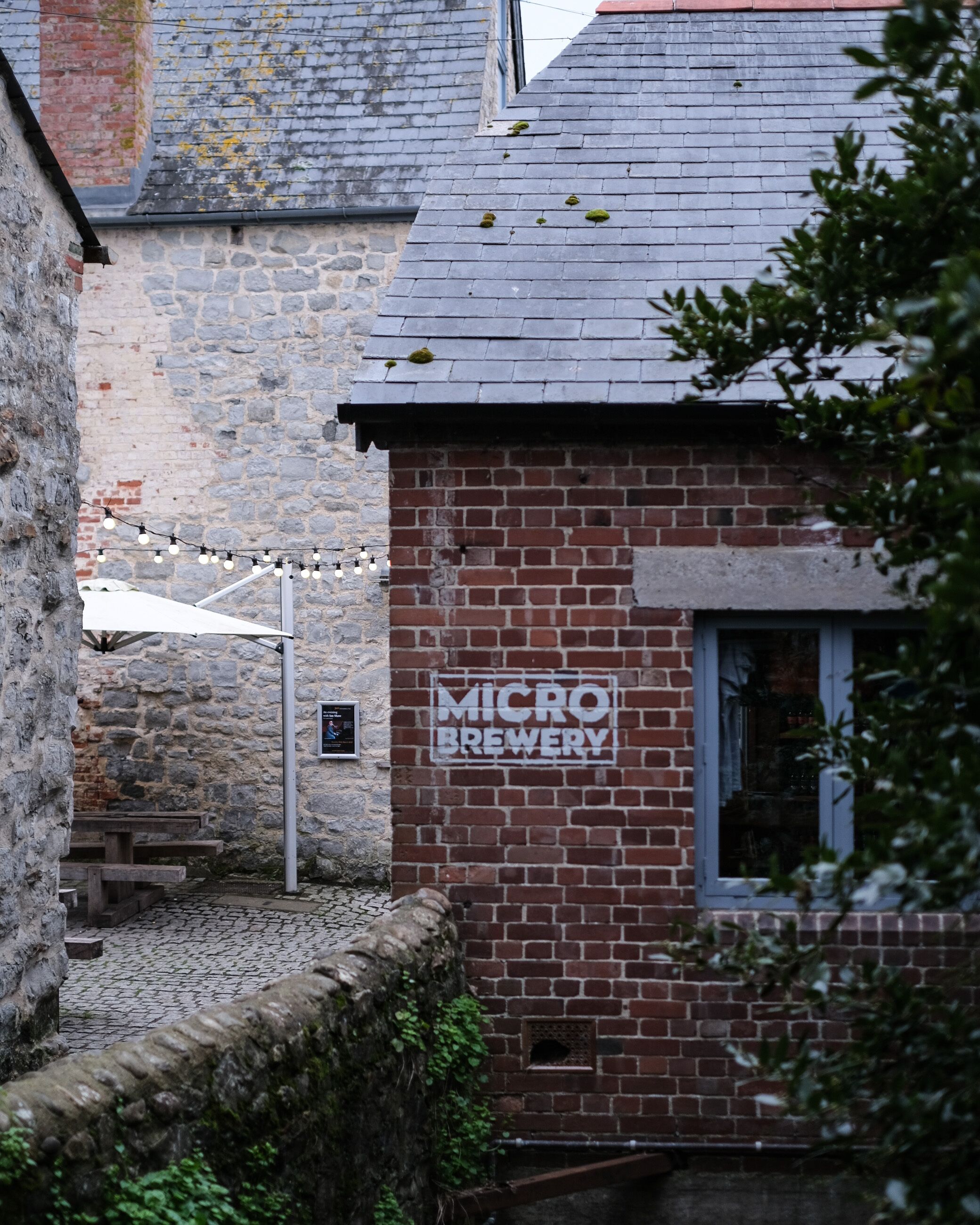 A brick building with a sign reading "MICRO BREWERY".