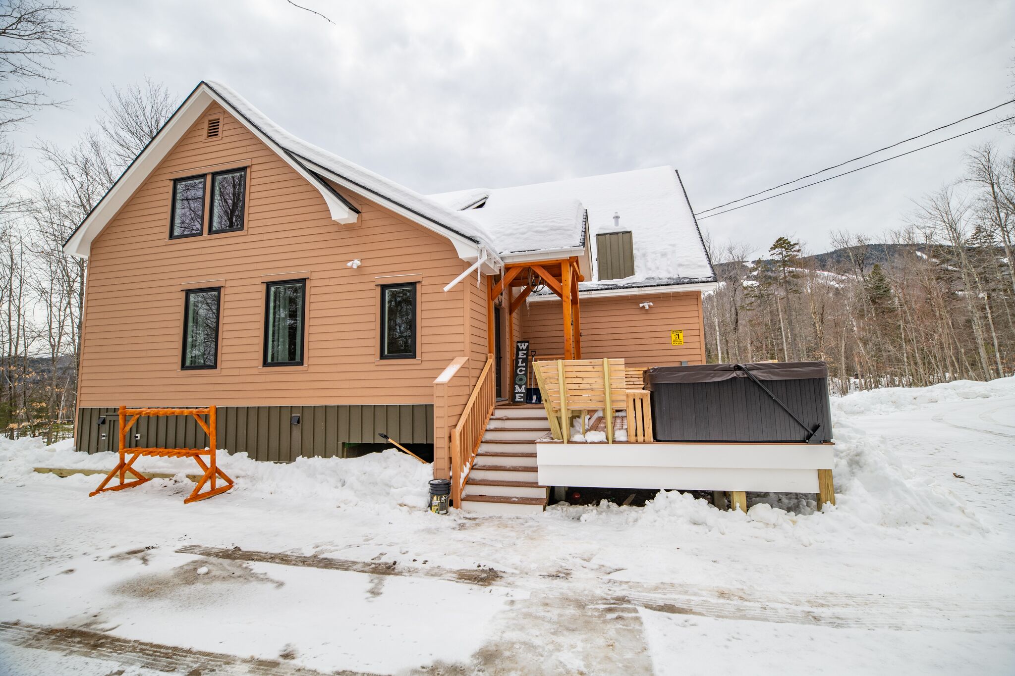 A two-story house with a porch and a covered entryway.