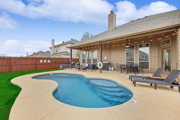 Enjoy a refreshing dip in the freeform pool surrounded by a spacious deck and outdoor seating area.