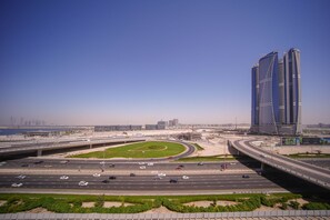 A highway interchange with multiple lanes and a large building in the background. - Spacious 2BR apartment with rooftop pool The Bay DT by 360 Vacation (Dubai)