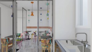 A modern kitchen with colorful chairs, a glass partition, and pendant lights. - Bhr Cavour 150 (Rome)