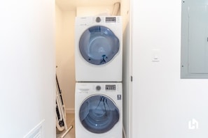 A laundry room with two stacked front-loading washing machines.