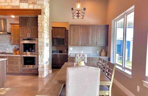 Enjoy meals in the kitchen with an oven and dining area featuring a table and chairs.