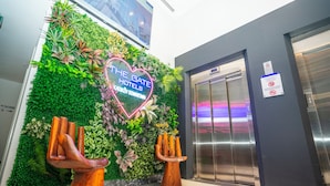 A hotel entrance with a green wall, a neon sign, and an elevator. - The Gate Hotels Kadıköy Downtown (Istanbul)