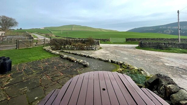 A rural landscape with a stone pathway leading to a gate, surrounded by stone walls and a grassy field. - Beautiful Rural 3BR Cottage with Stunning Views - Pass the Keys (Dumfries)