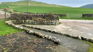 A rural landscape with a stone wall, a paved path, and a grassy field. - Beautiful Rural 3BR Cottage with Stunning Views - Pass the Keys (Dumfries)