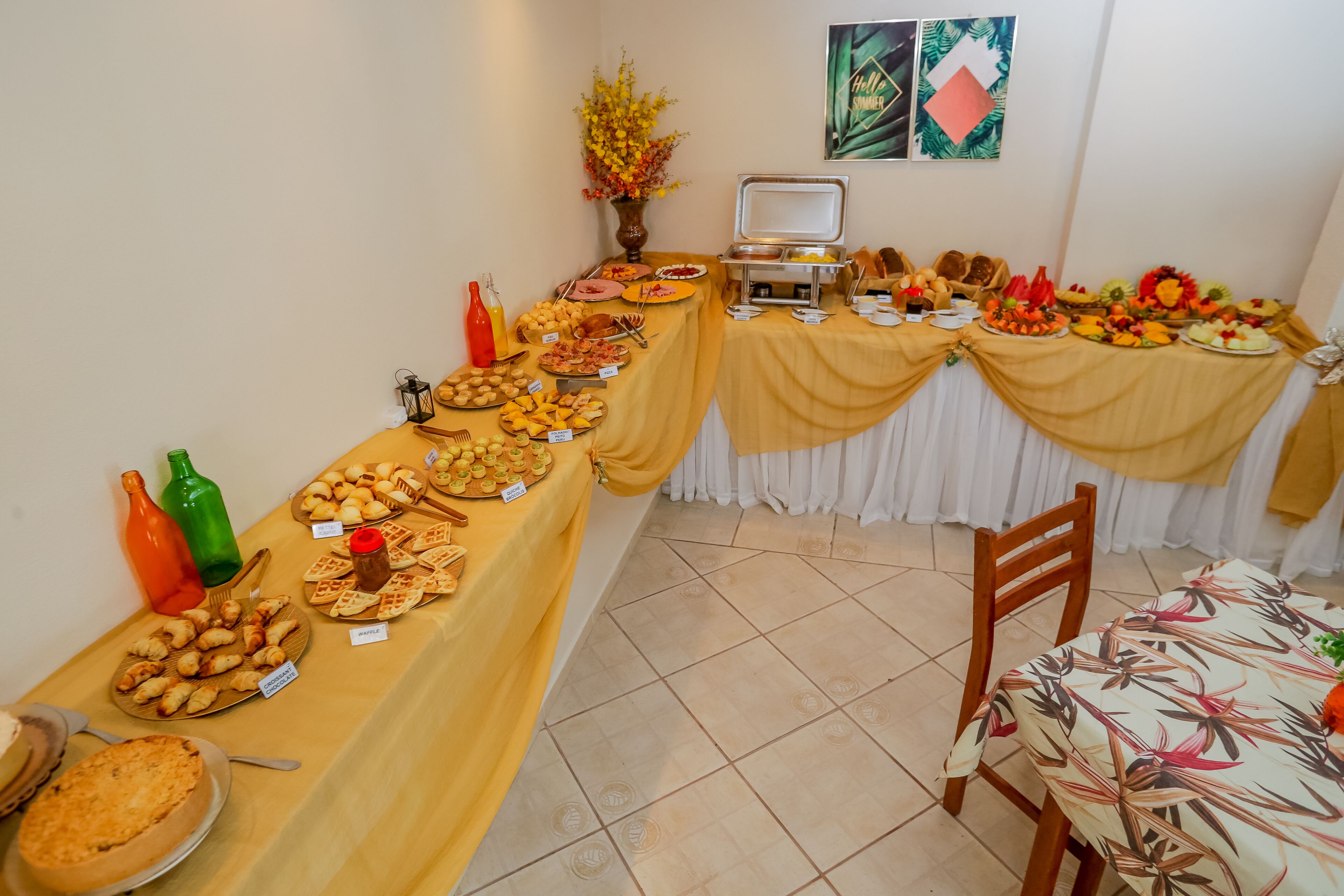 A buffet table with various food items and a beverage station.