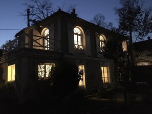 A two-story building with arched windows and a balcony. - Charming little house - Paris. Versailles - Roland Garros - Golf - Normandy (Garches)