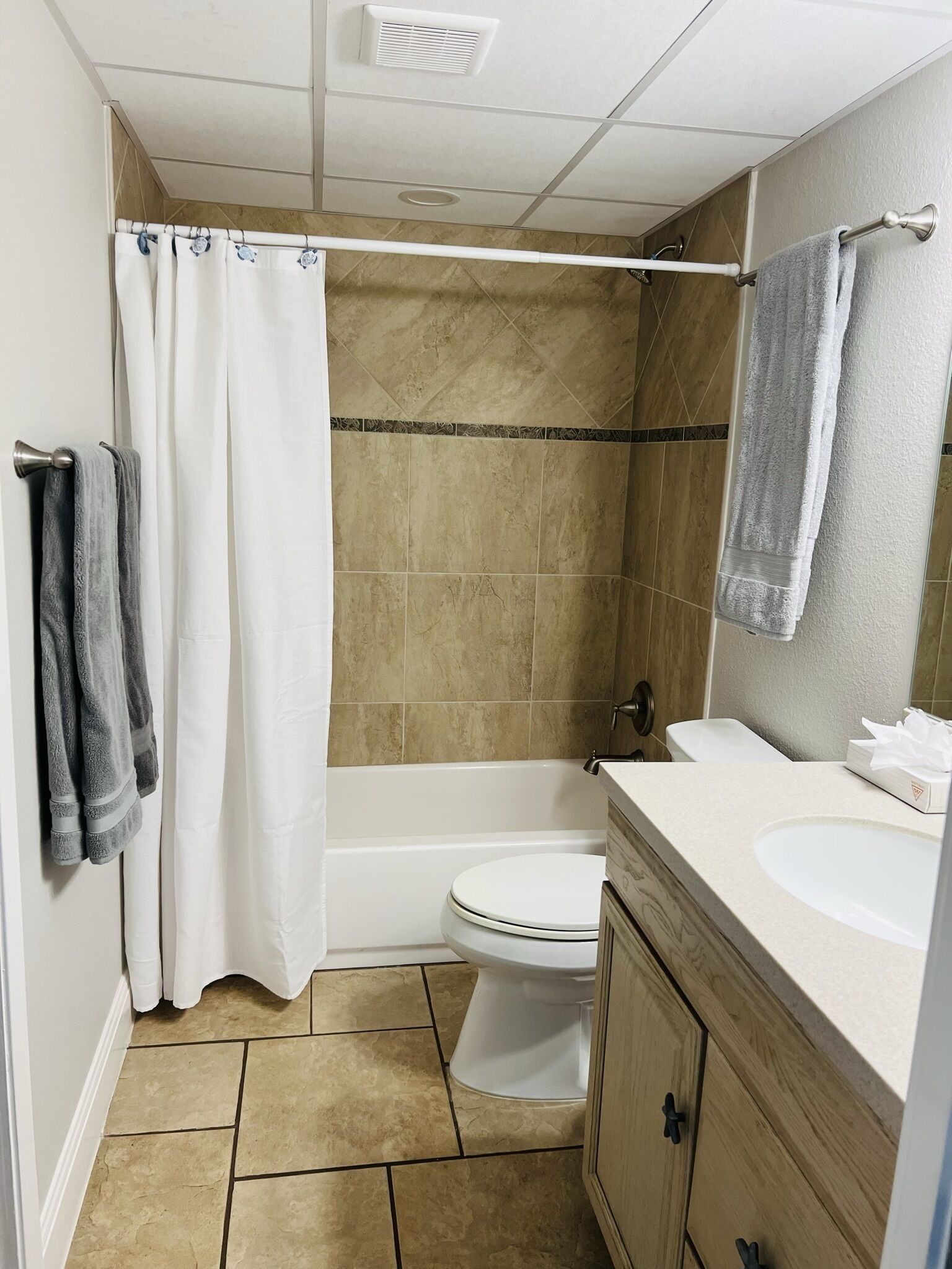 Tina con regadera, toallas, jabón, papel de baño 