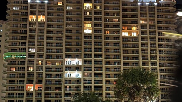 A multi-story hotel with balconies, a central atrium, and a rooftop terrace. - Gorgeous Ocean and Bayside View (Miramar Beach)