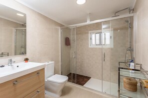 A modern bathroom with a glass shower enclosure, a white sink, and a toilet. - Villa Alegria - Two Bedroom Villa, Sleeps 4 (Torrox)