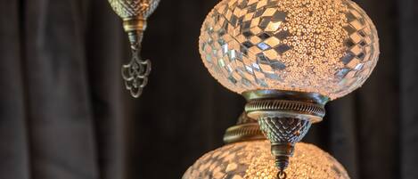 A chandelier with intricate metalwork and multiple spherical glass shades.