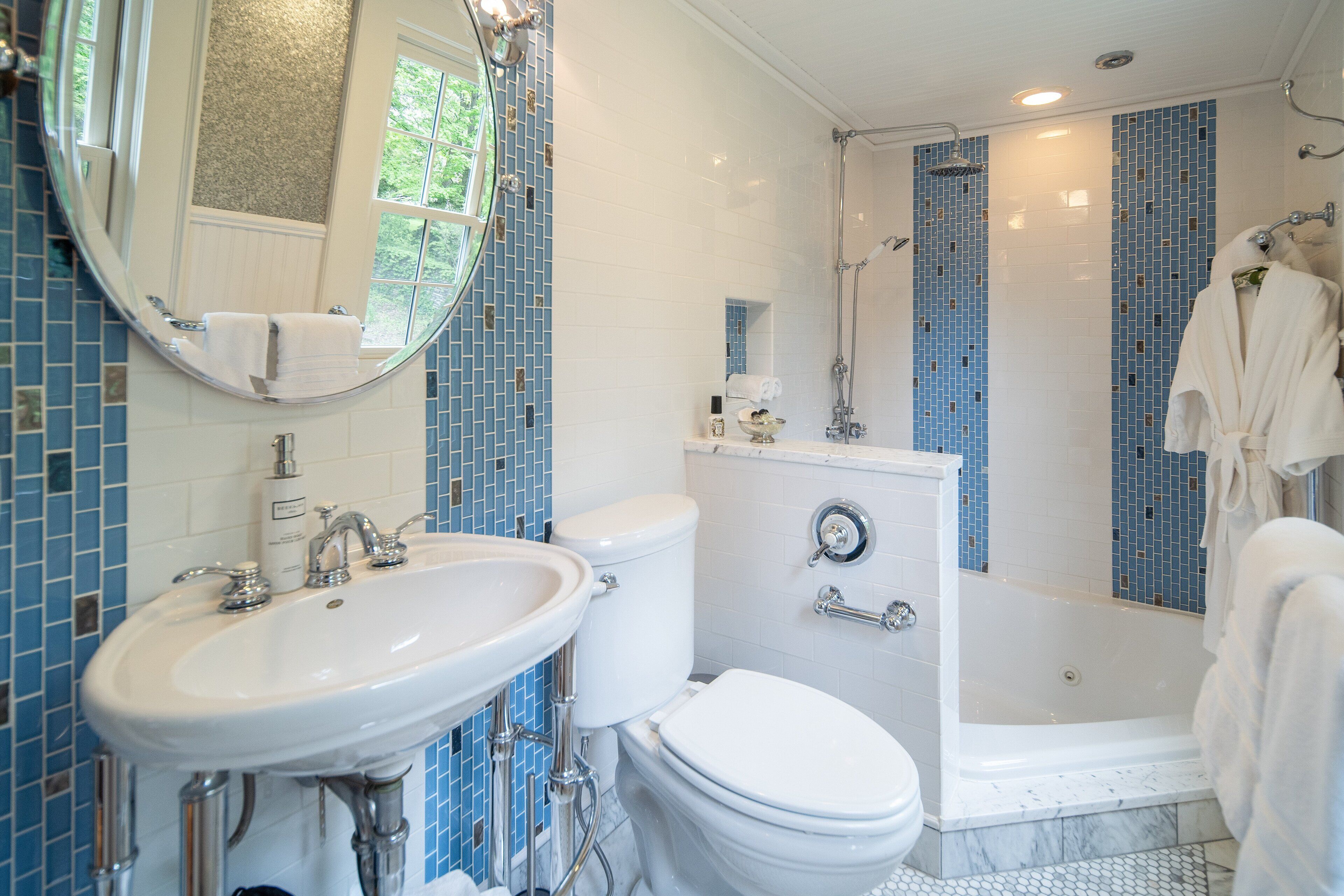 A bathroom with a white sink, toilet, and shower.