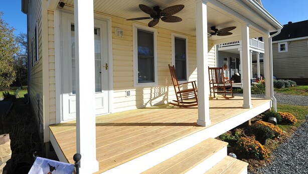 A house with a porch, two rocking chairs, and a ceiling fan. - Walking distance to shopping, restaurants, entertainment, and the Chesapeake Bay (Rock Hall)