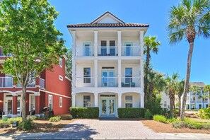 A two-story building with a white facade, multiple balconies, and a central entrance. - ☀Steps 2 Lagoon Pool-Beautiful Decor-2 Balconies-6BR Changes in Latitude VCB (Destin)