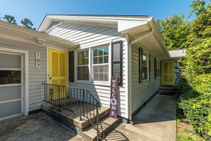 A single-story house with a front porch, a garage, and a mailbox. - Elon Dream Home: Spacious Retreat w/ Private Game Room (Gibsonville)
