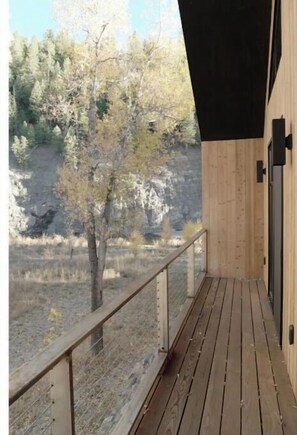 Enjoy the serene view from this balcony overlooking the surrounding landscape.