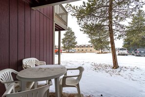 Relax in a cozy outdoor seating area with a table and two chairs, perfect for taking in the surroundings.