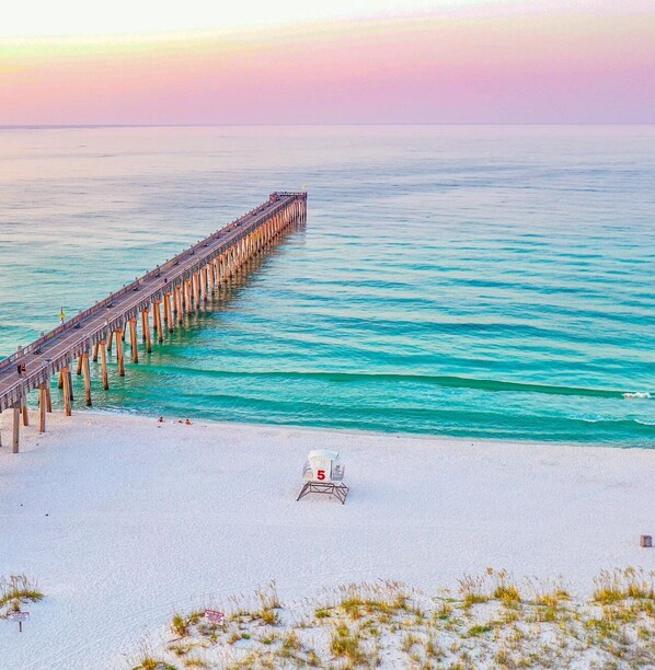 Walk along the pier, taking in the serene ocean views and enjoying the designated lifeguard area.