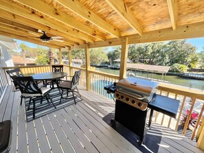 Enjoy a meal on the deck overlooking the water, where a barbecue grill and comfortable seating await.