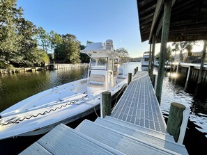 Docked at the water's edge, this boat offers a covered seating area and easy access to the surrounding waters.