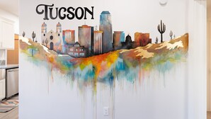 A vibrant mural of a cityscape with the word "Tucson" prominently displayed.